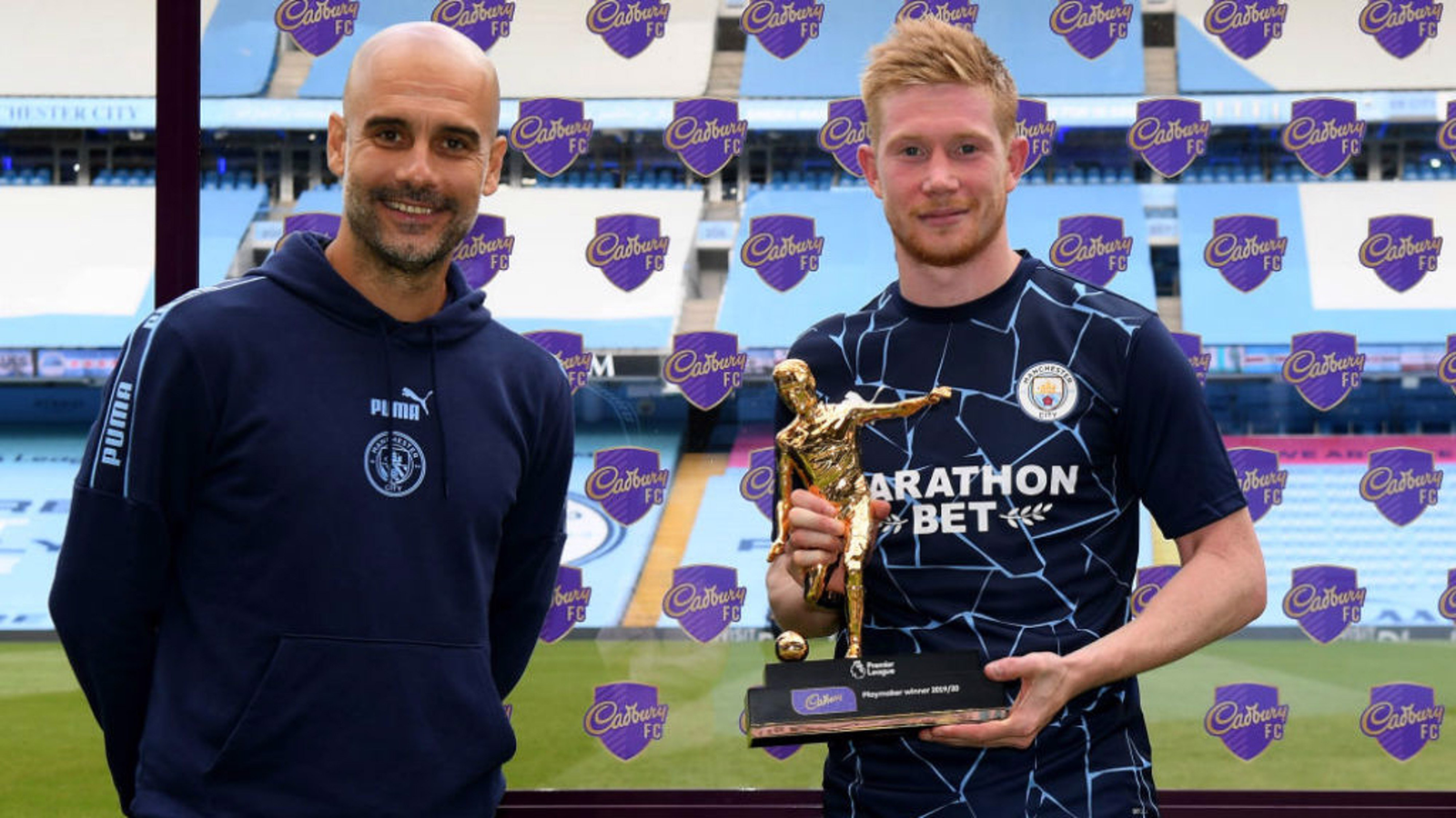 De Bruyne holding the playmaker award trophy.